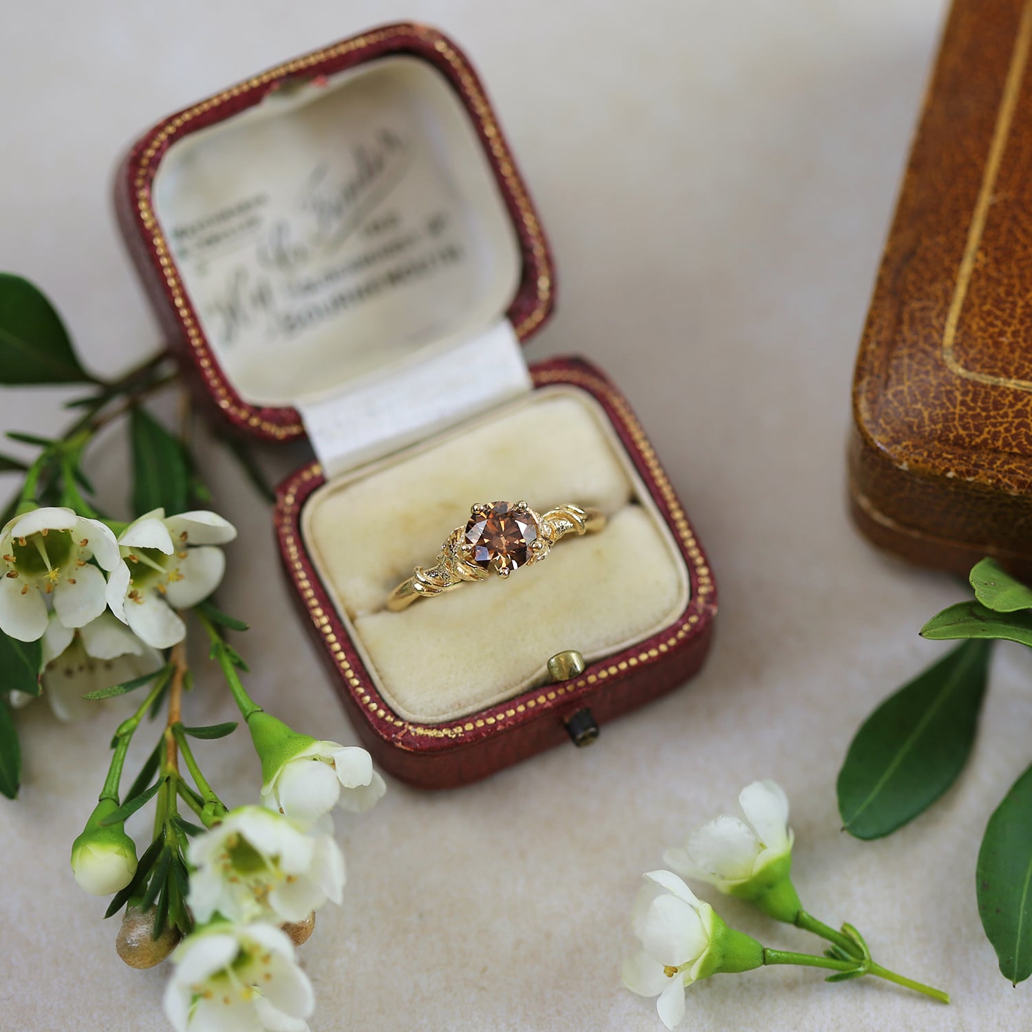 Lock and Key Necklace gold plated silver with black seed pearls displayed on vintage books with peach coloured flower