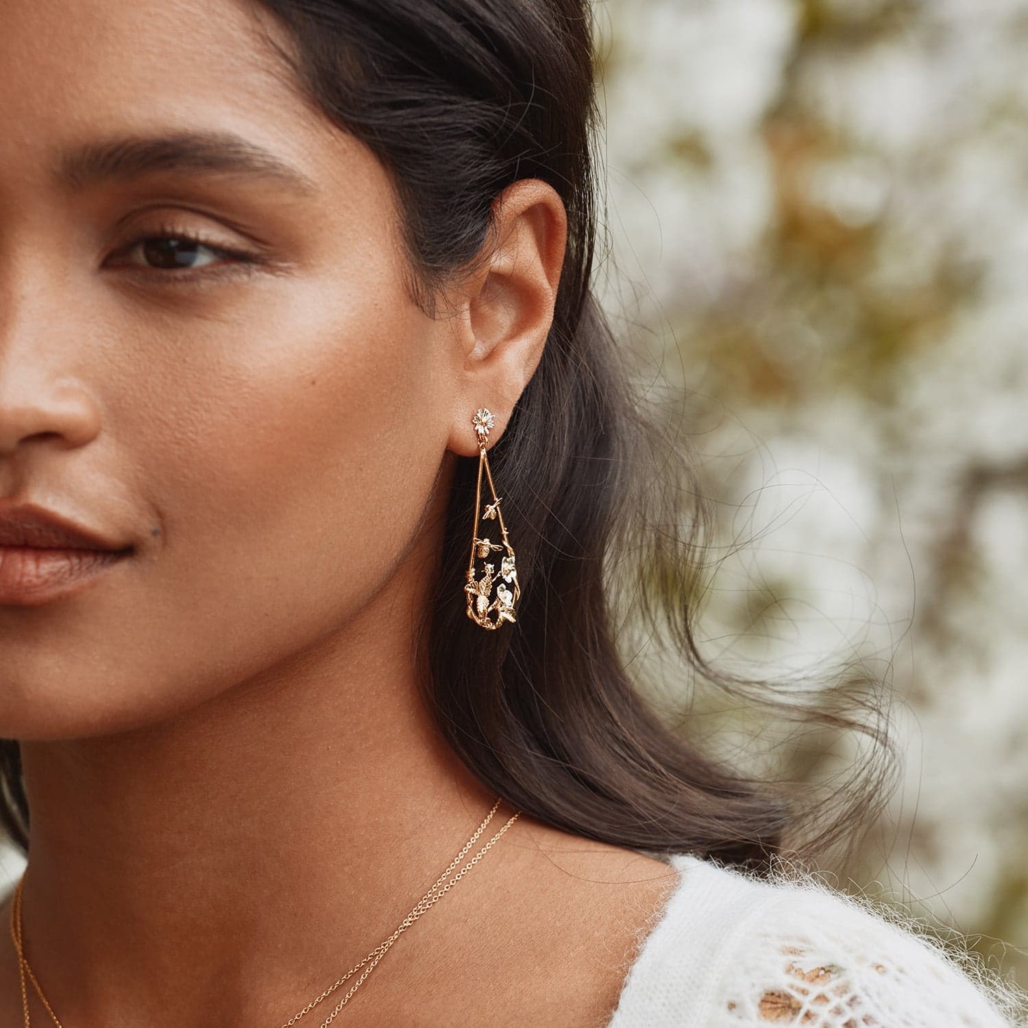 model wearing statement strawberry patch teardrop earrings with buzzing bees, gold-plated with silver details by Alex Monroe Jewellery